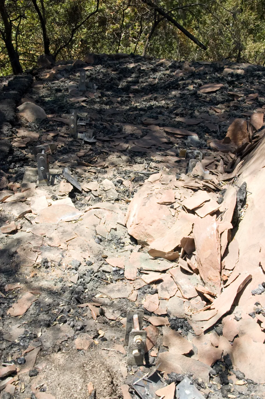burned, flaking sandstone in the remains of the burned Home Demonstration deck after the Jesusita Fire