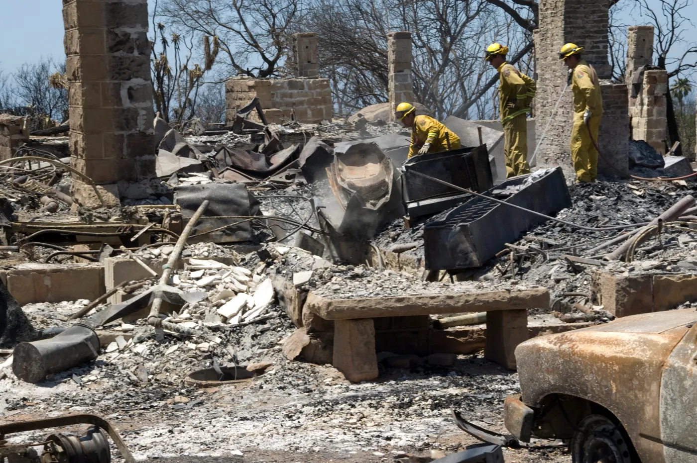 Firefighters put out a hot spot at the Gane House site, after the Jesusita Fire
