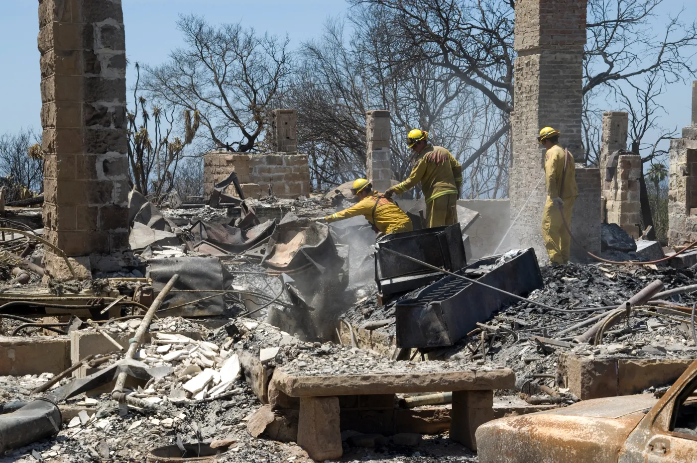 Firefighters put out a hot spot at the Gane House site, after the Jesusita Fire
