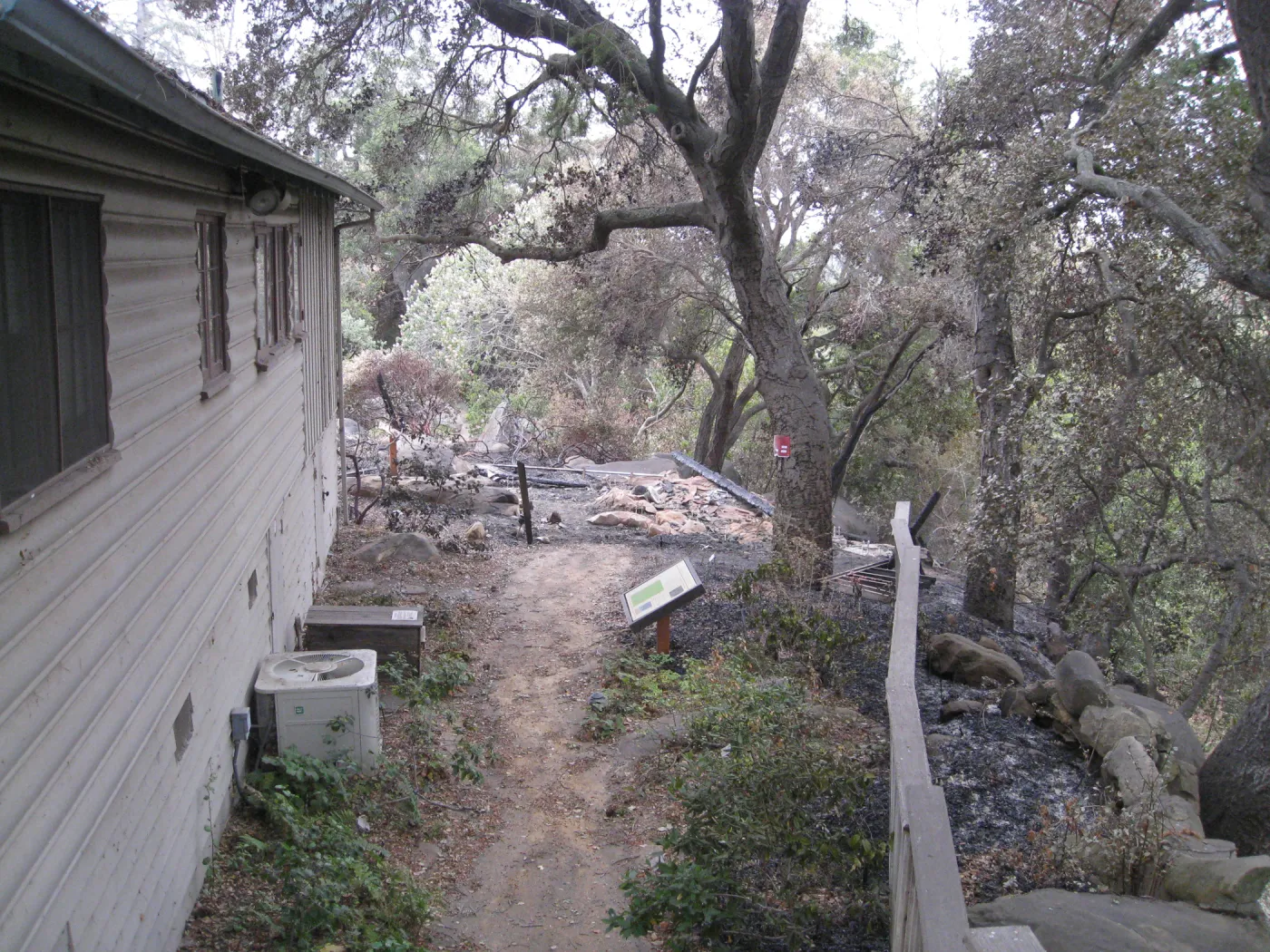 Path on west side of the Cottage, burned ramains of the Home Demonstration Deck after the Jesusita Fire