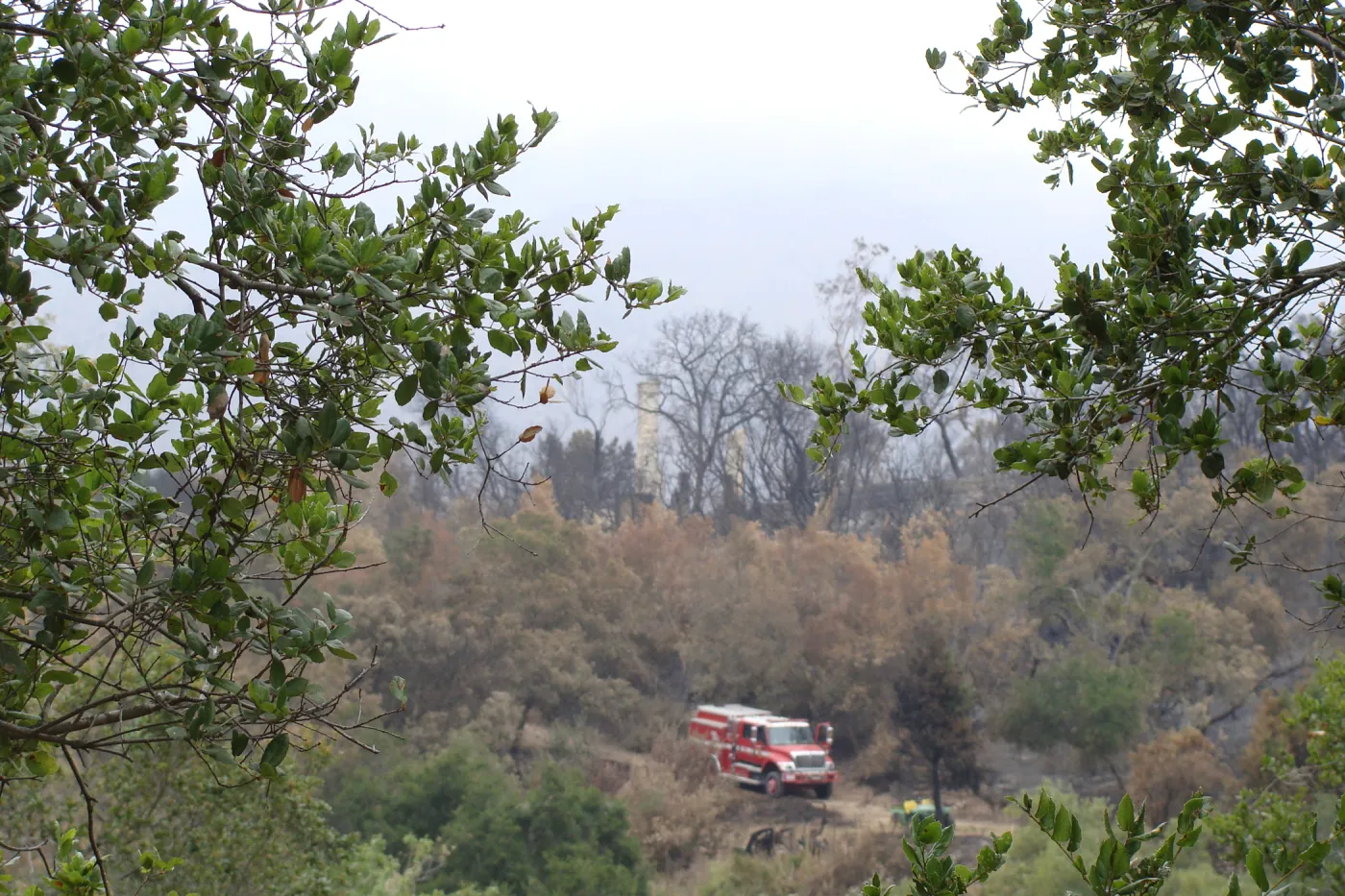 Fire truck parked below the burned remains of the Gane House, after the Jesusita Fire
