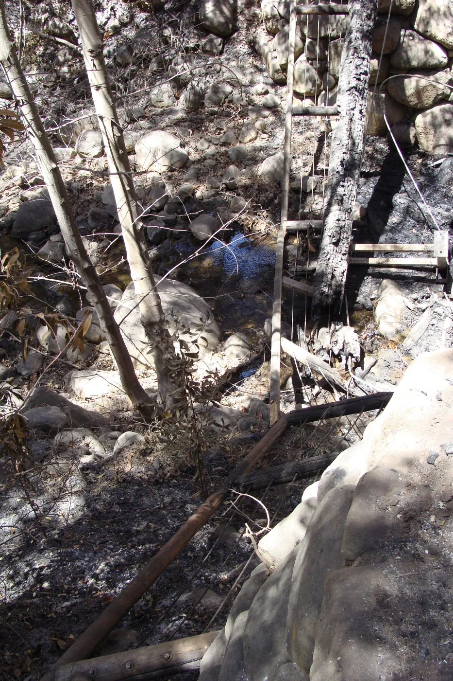 Campbell Bridge railing laying in Mission Creek, after the Jesusita Fire