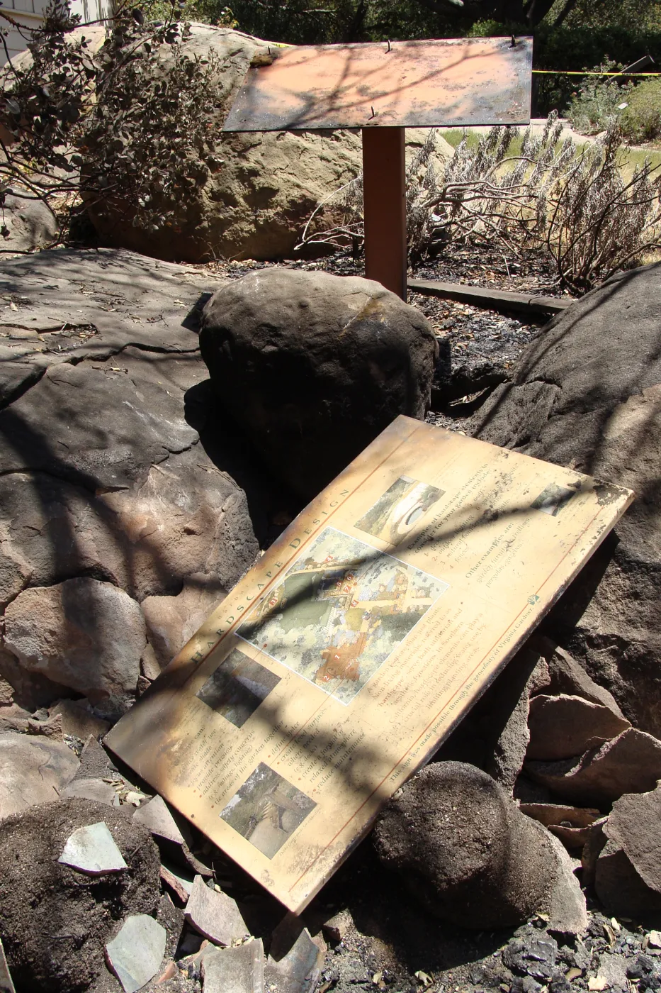 burned 'Hardscape Design' sign and debris from the Home Demonstration Deck, after the Jesusita Fire