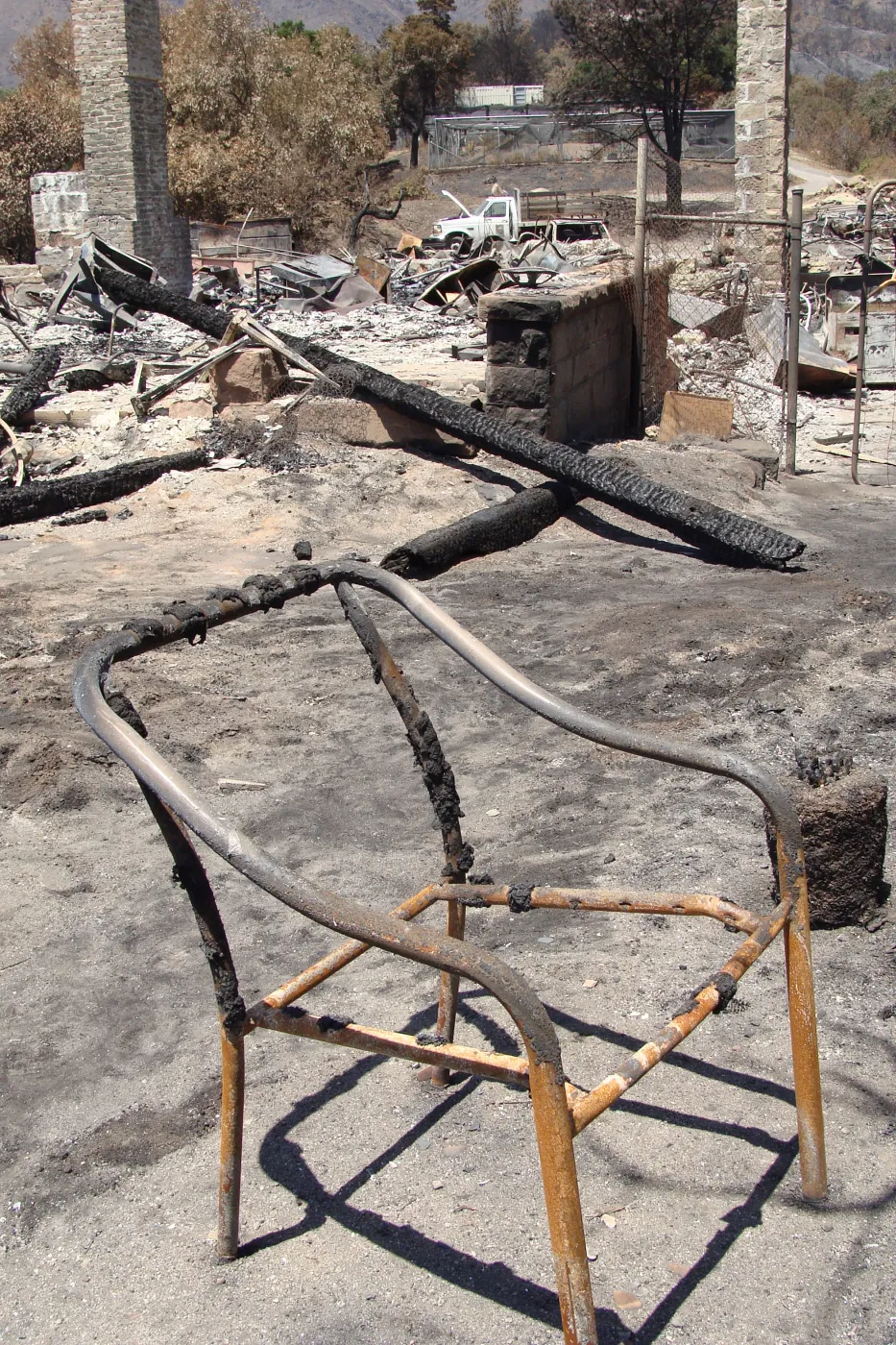 burned chair frame and debris, after the Jesusita Fire
