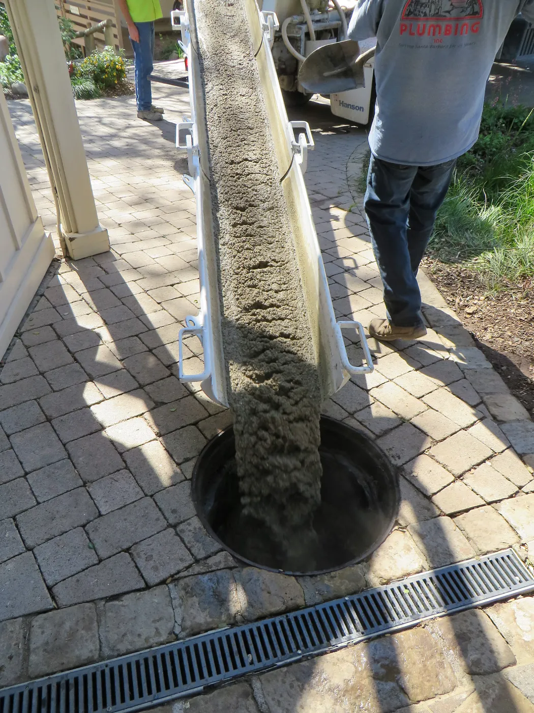 Filling septic tank at entrance with cement slurry