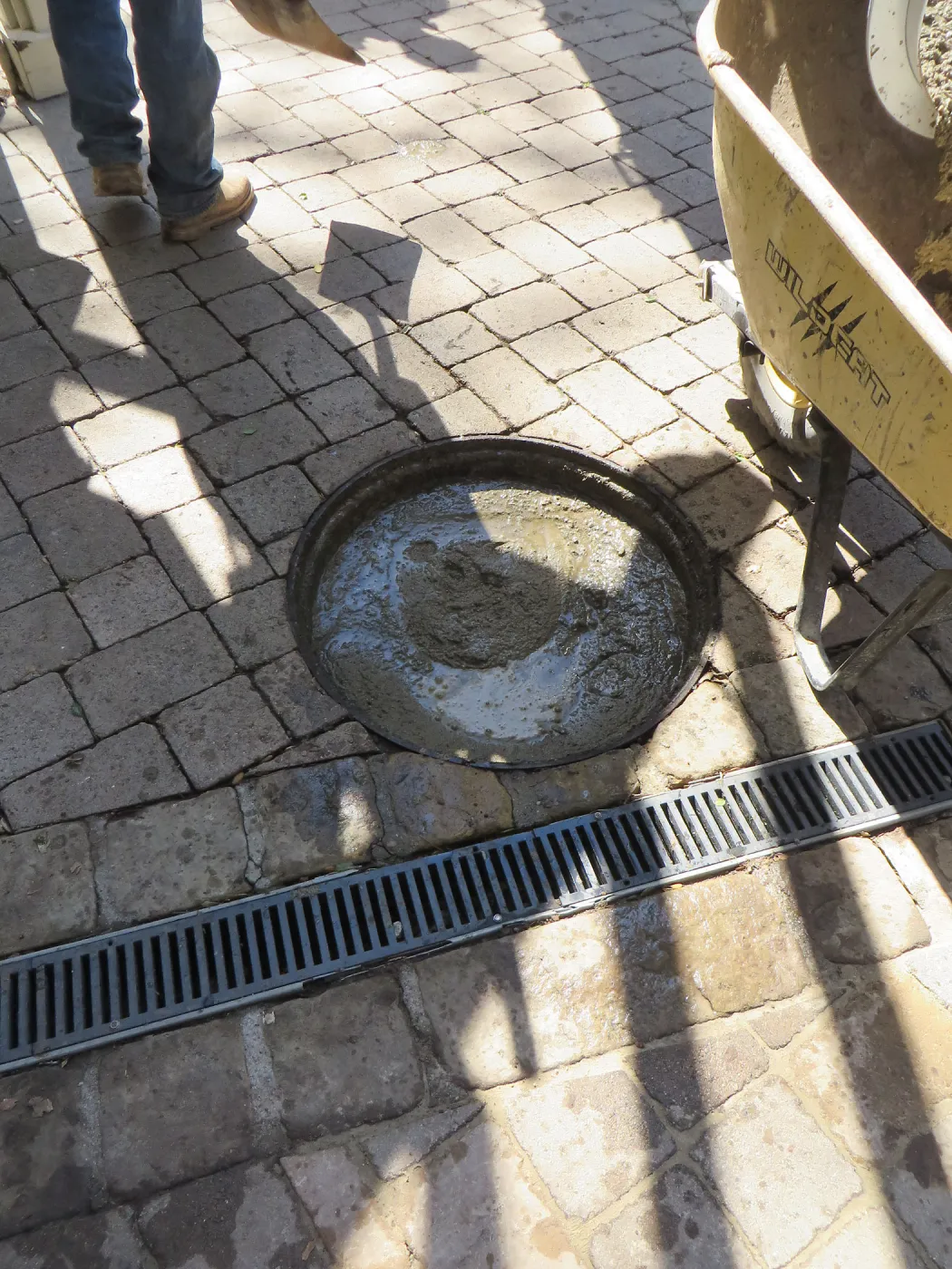 Filling septic tank at entrance with cement slurry