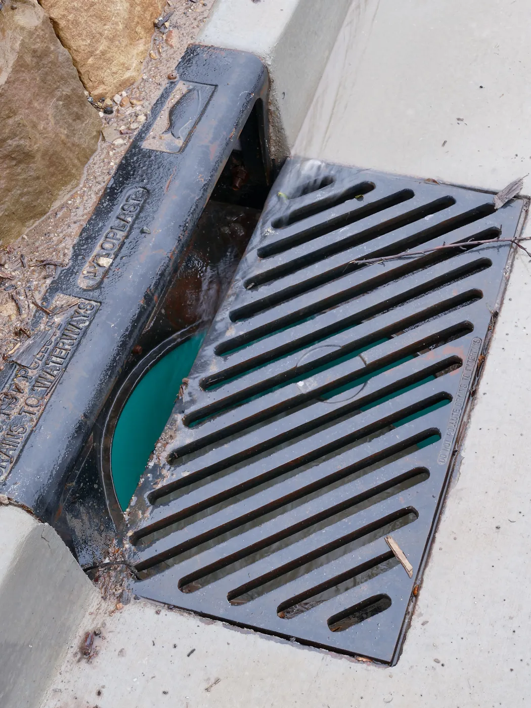 Rainwater entering a storm drain leading to the Pritzlaff Conservation Center bioswale