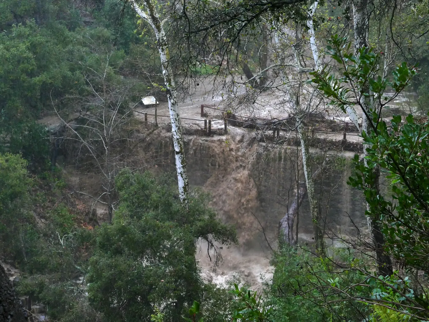 Mission Creek cresting Mission Dam during rainstorm