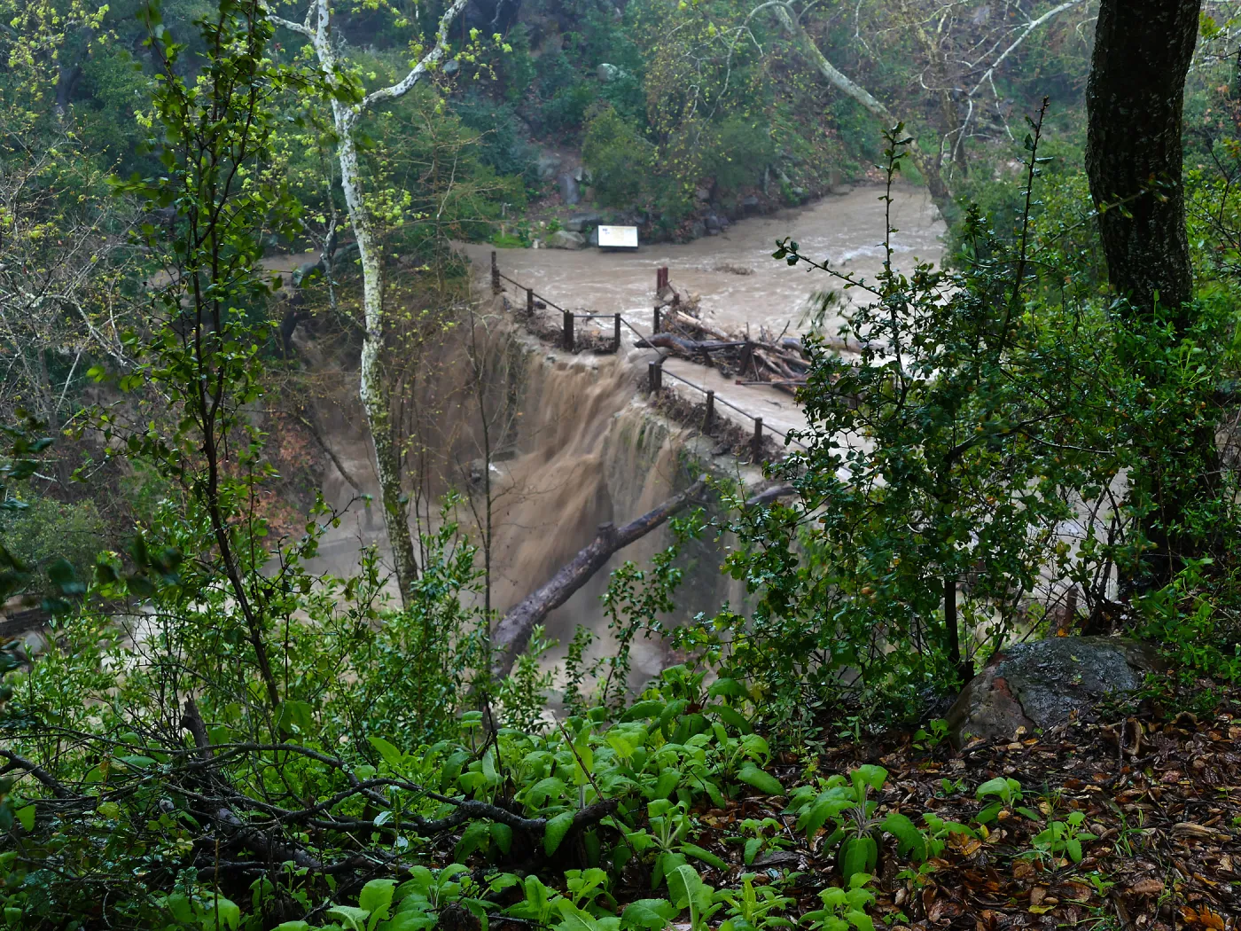 Mission Creek cresting Mission Dam during rainstorm