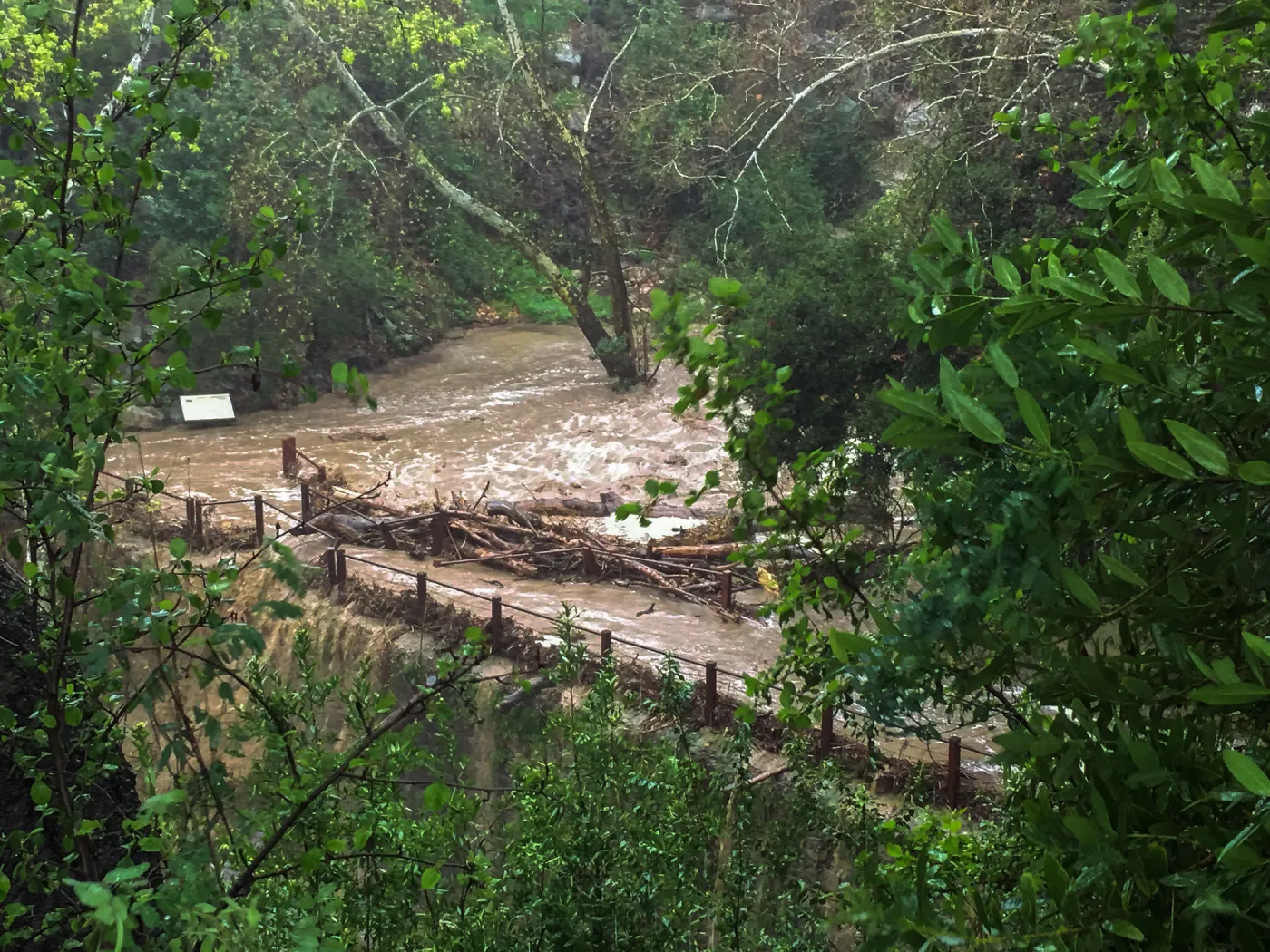 Debris accumulation at Mission Dam during rainstorm