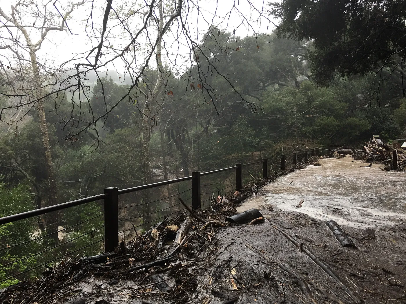 Debris accumulation at Mission Dam during rainstorm
