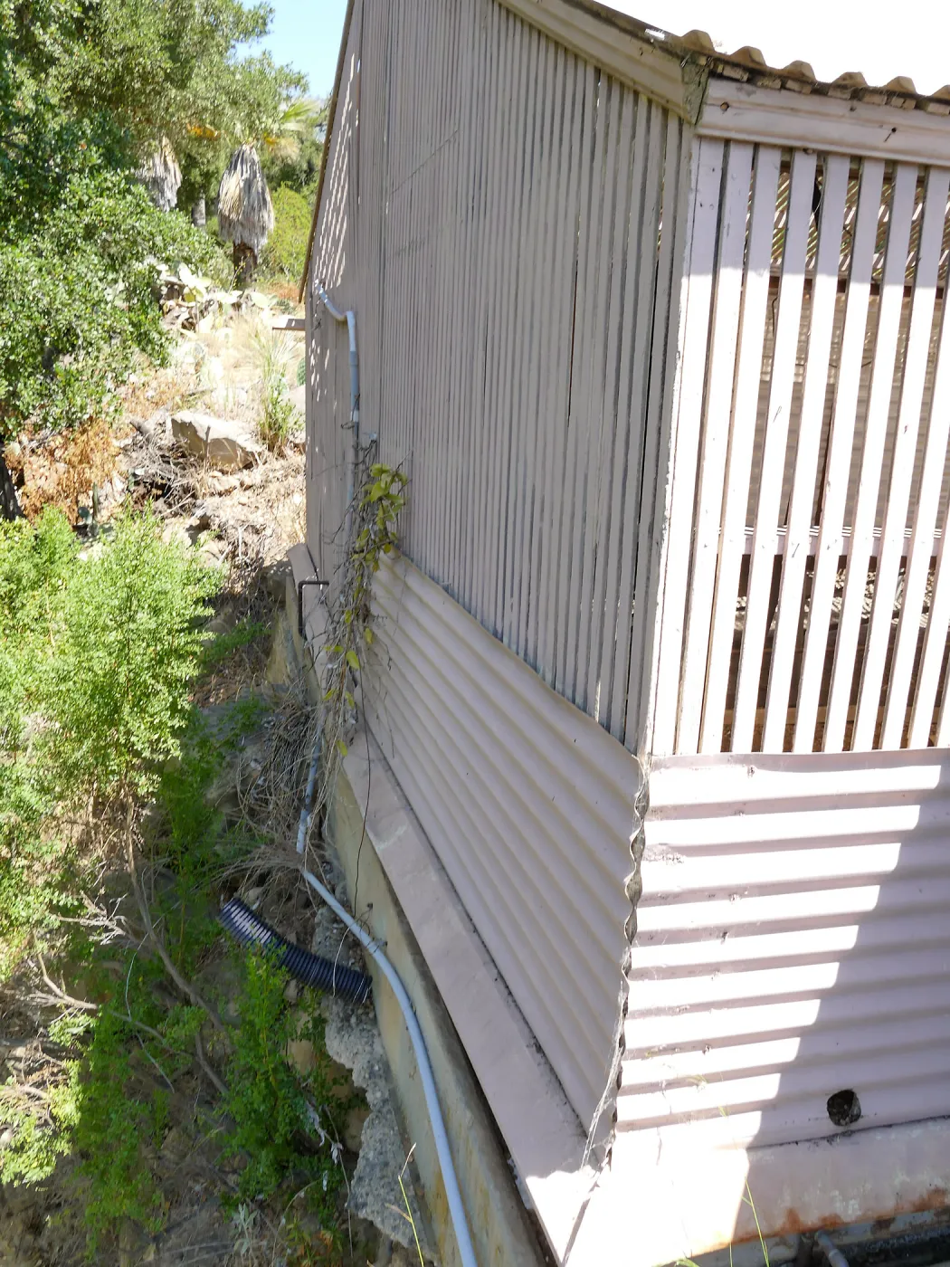 Garden Growers Lath House before start of repairs. Looking north across west wall exterior.