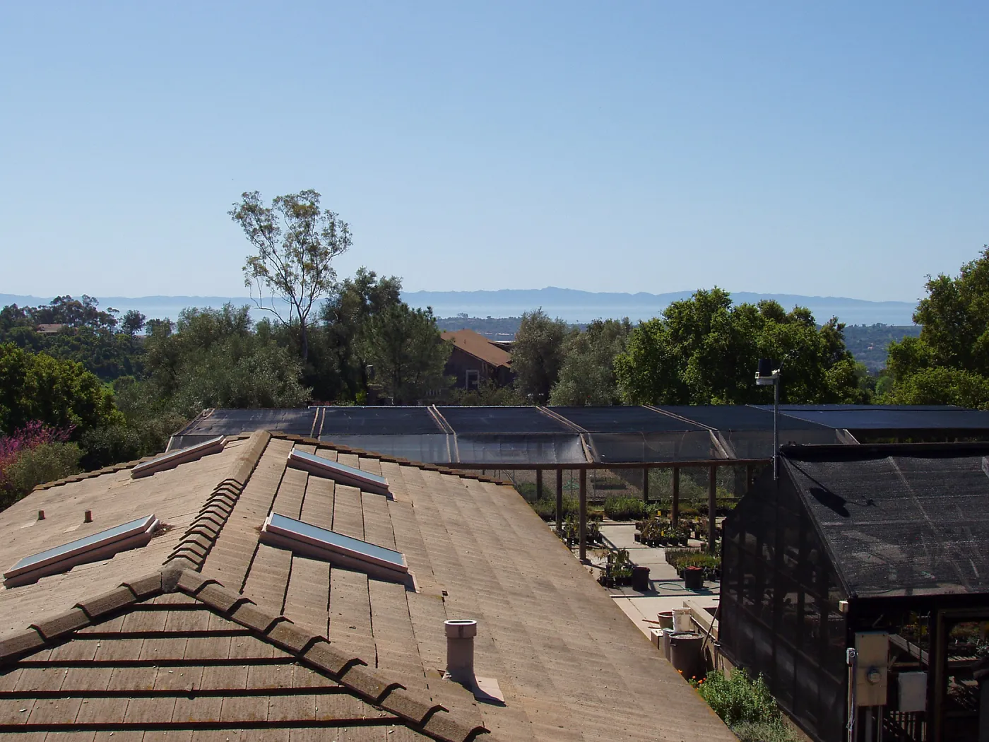 View looking south from upper parking area over Horticulture Unit roof
