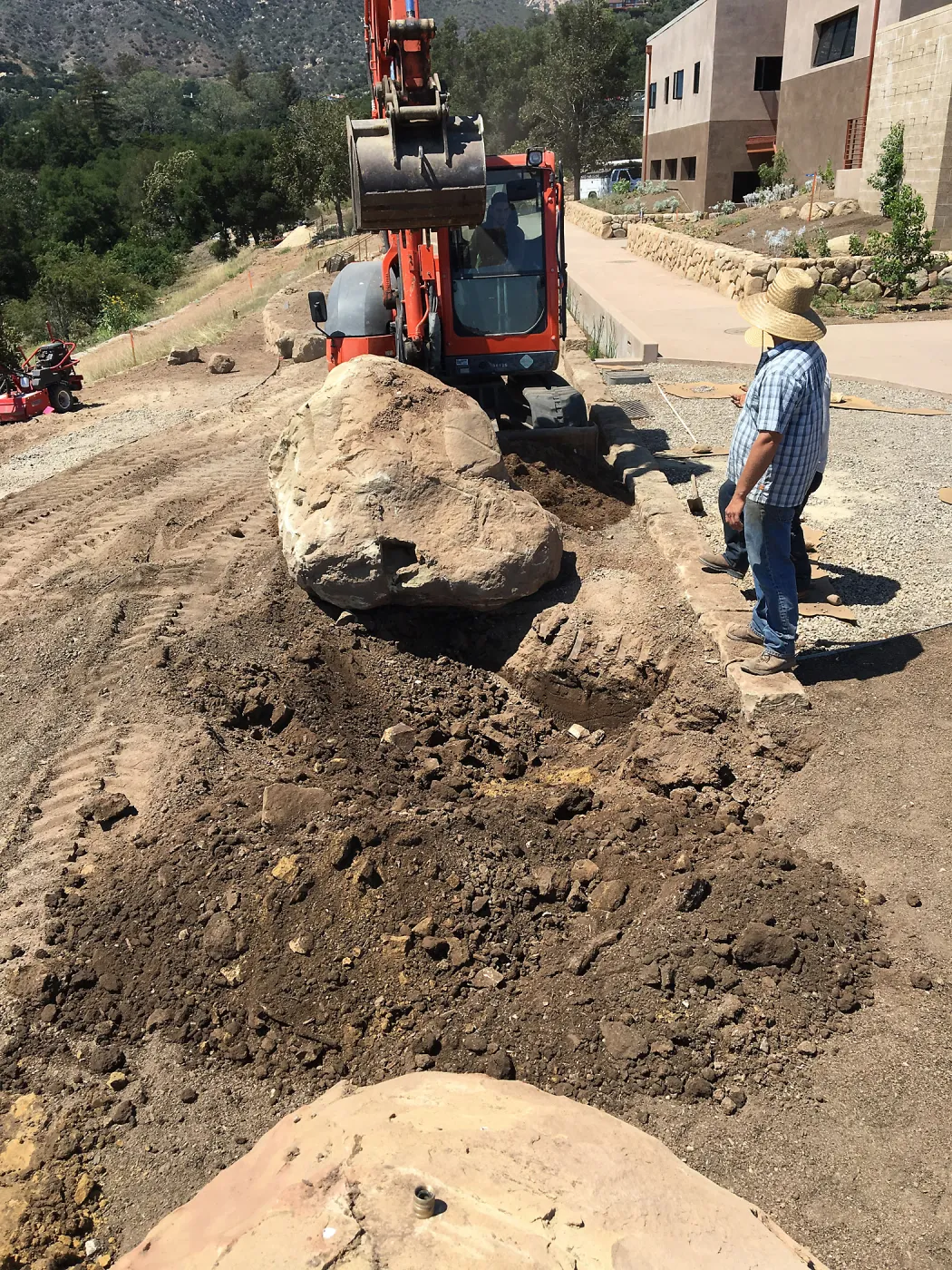 Moving boulder behind island sculpure into place. Island View Garden construction