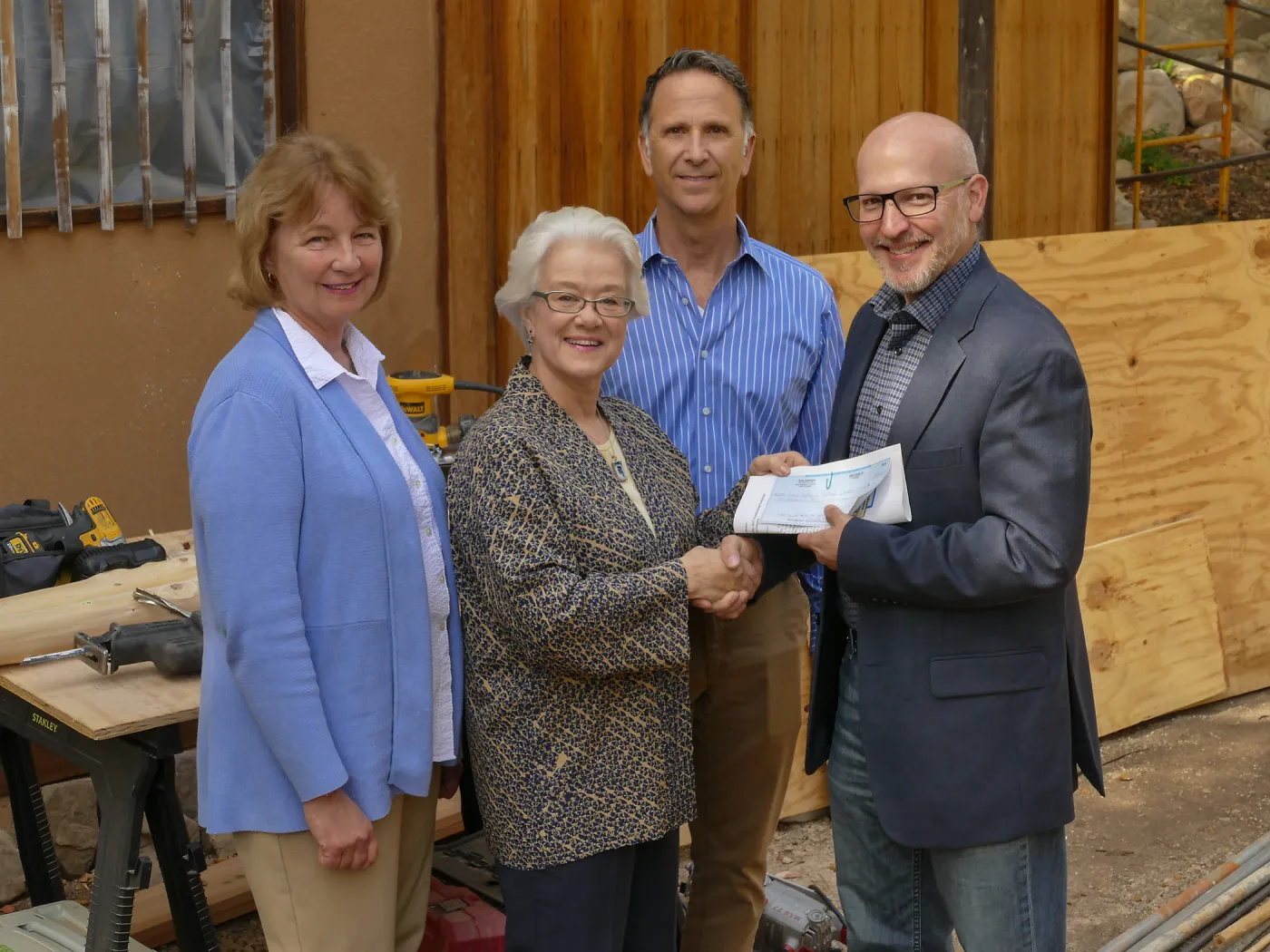 Linda Mathews, Chair of the Teahouse Improvements Fundraising Committee, gives Steve Windhager donations totaling $8,000 from the tea house volunteers to launch the fundraising for the repairs and improvements of the Teahouse and Tea Garden in 2017-2018