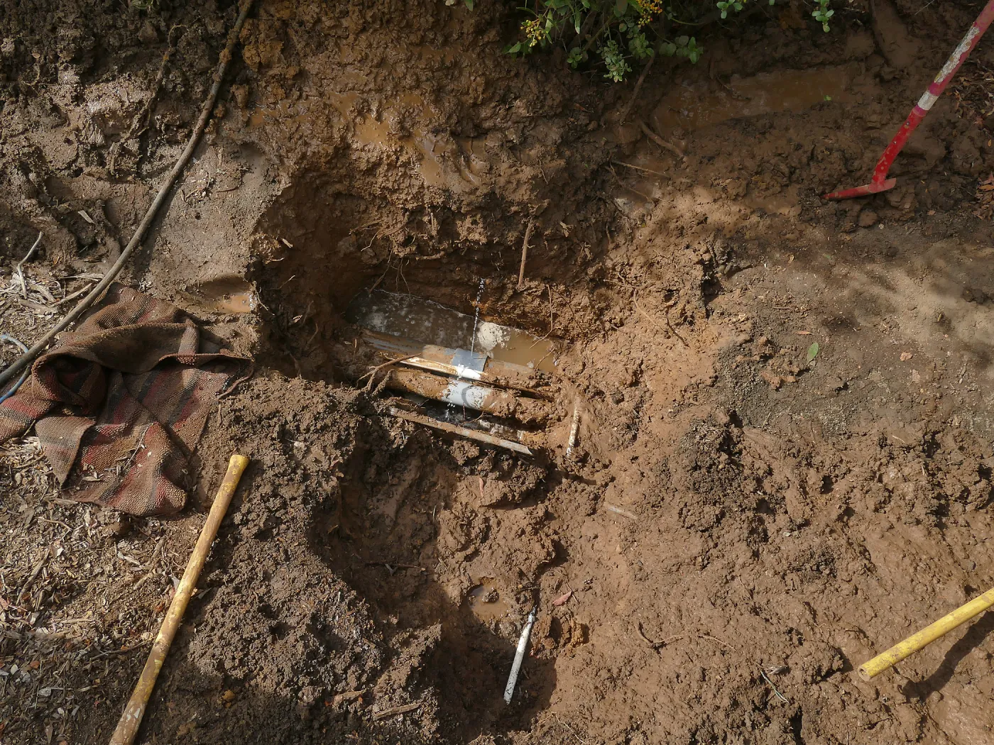 Broken 4 inch irrigation water pipe in Porter Trail section, taken from east side of hole.