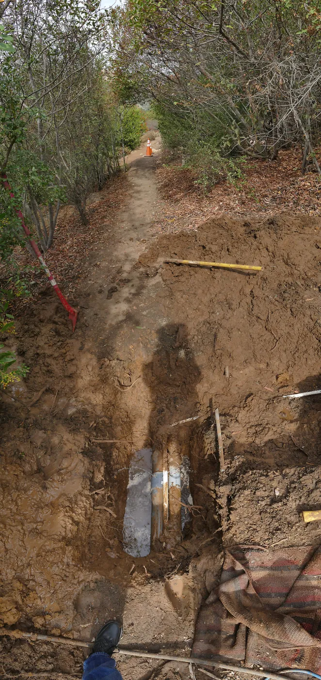 Broken 4 inch irrigation water pipe in Porter Trail section, looking north