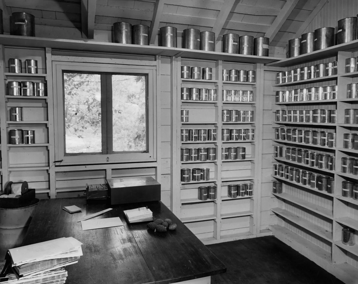 The historic 'Seed Room', seeds stored in metal cans arranged on wall shelves