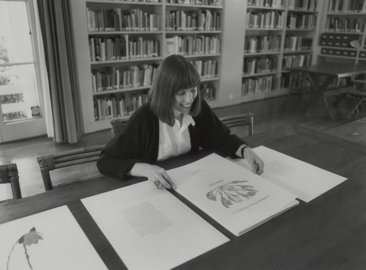 Nancy Hawver in Blaksley Library examining Henry Evans portfolio