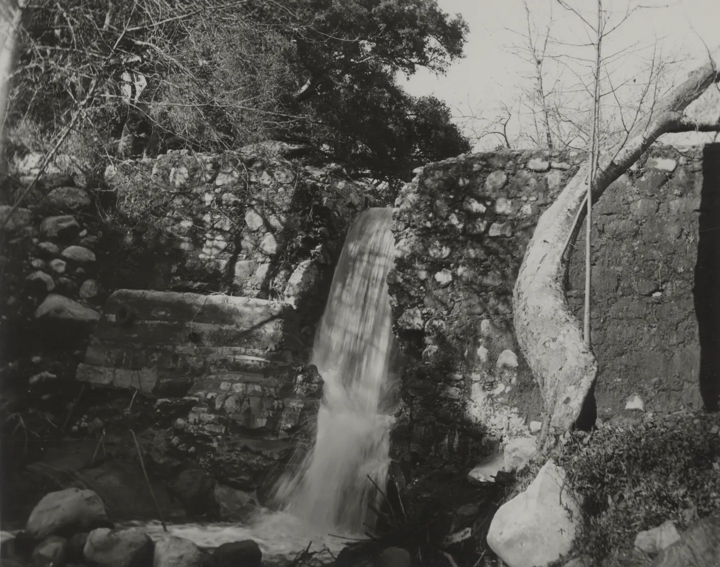 waterfall flowing over Mission Dam, circa 1920's