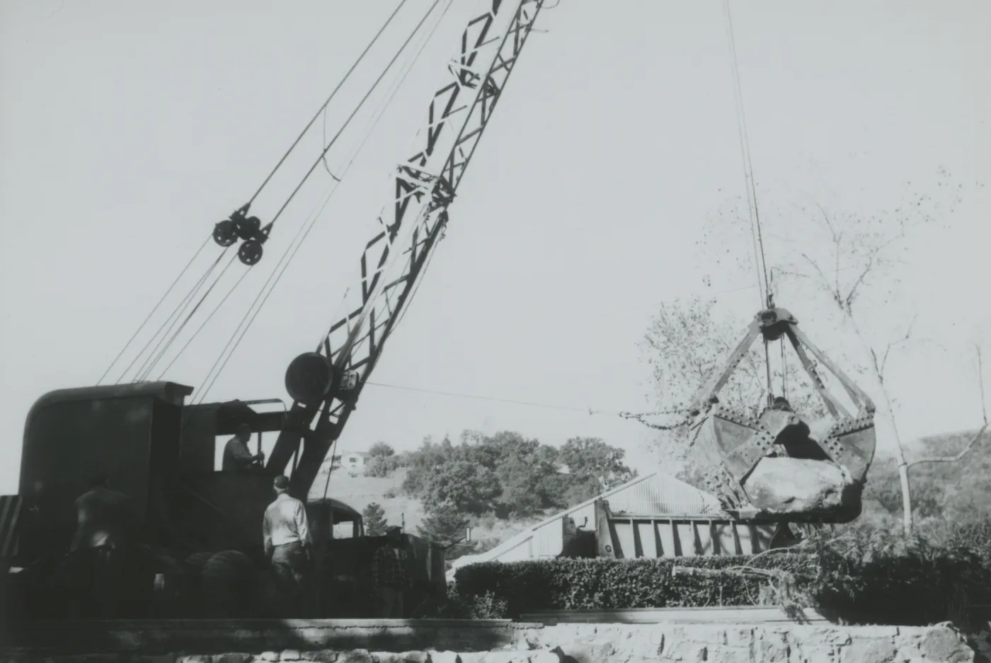 North Wing construction, crane moving boulders