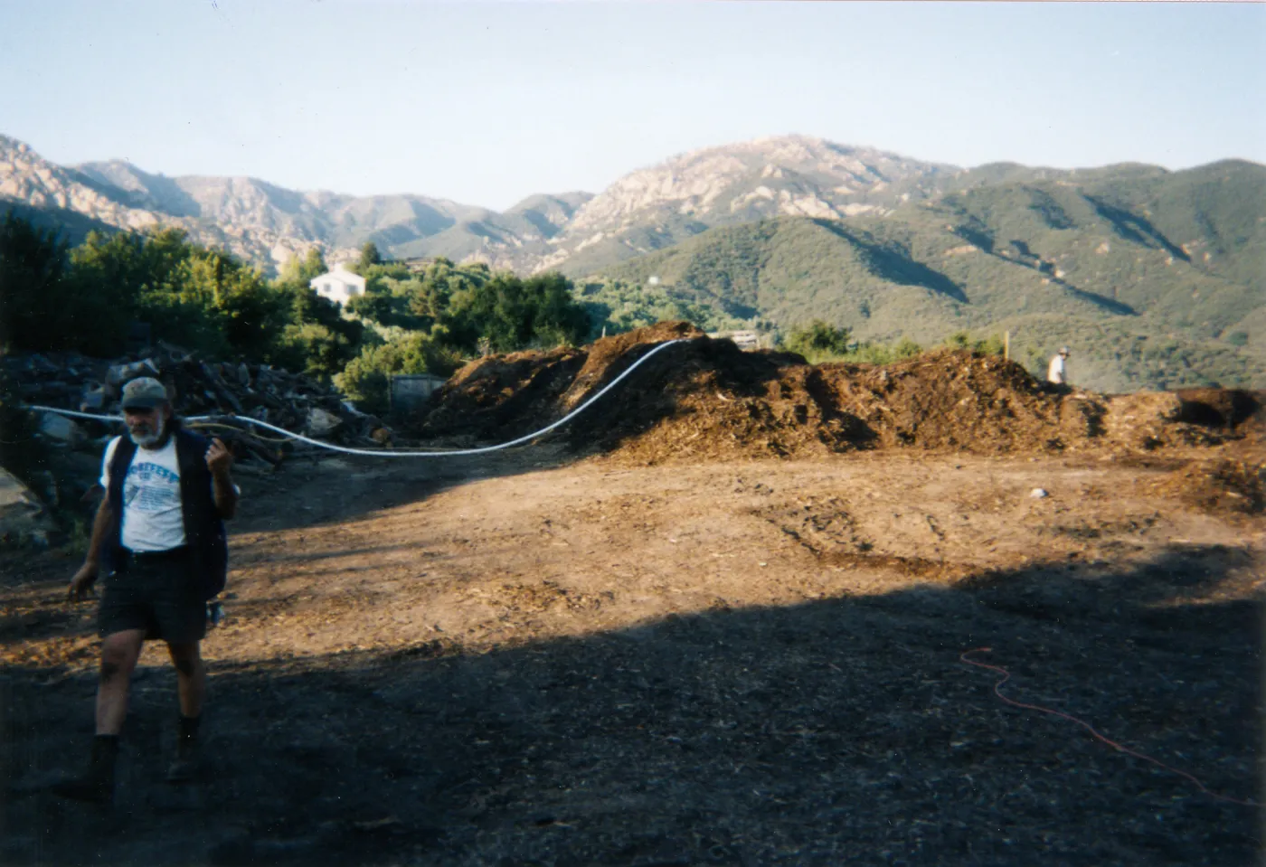 Geege Ostroff at mulch pile on ridge above Hort Unit that caught on fire and was removed
