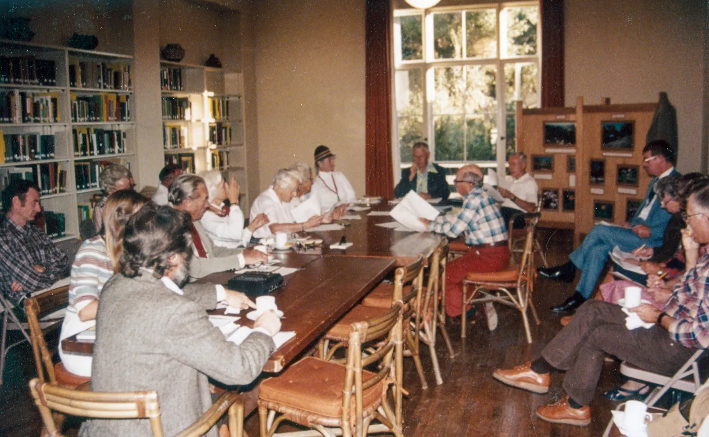 Board Members: Man at head of table (facing camera): Dr. William Stewart. Man on right side of table w/orange slacks & glasses: Campbell Grant