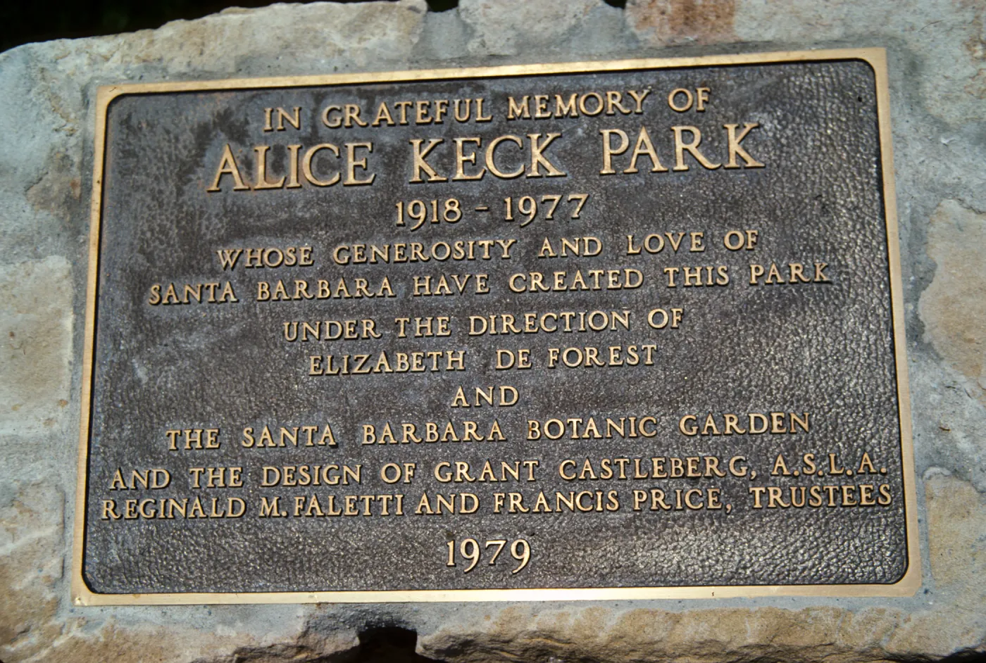 A brass-colored plaque that reads "In greateful memory of Alice Keck Park. 1918-1977, whose generosity and love of Santa Barbara have created this park under the direction of Elizabeth Forest and the Santa Barbara Botanical Garden and the design of Grant Castleburg A.S.L.A. Reginald M. Faletti and Francis Price, trustees, 1979."