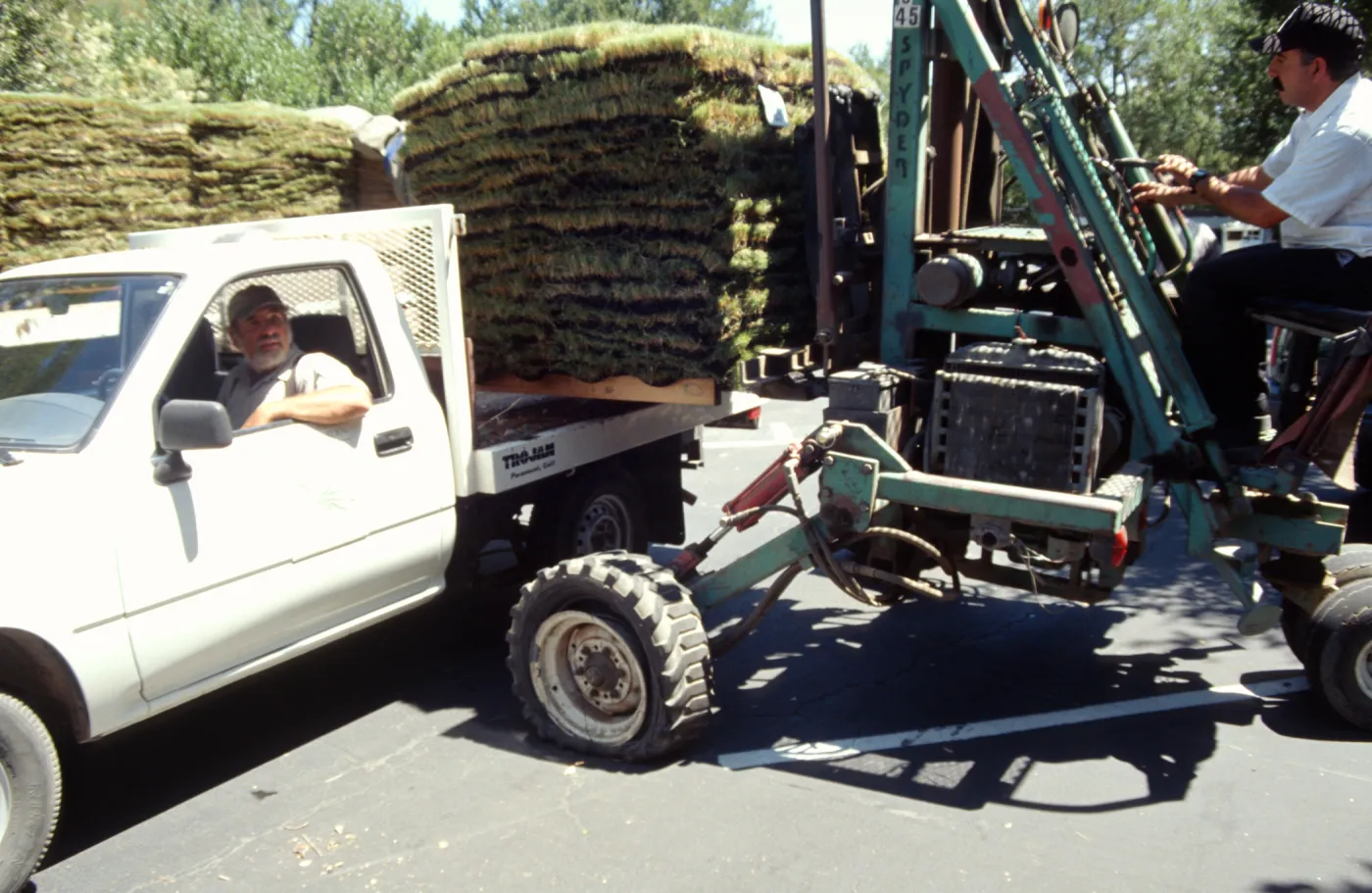 tractor unloading sod for the new Meadow lawn Installation
