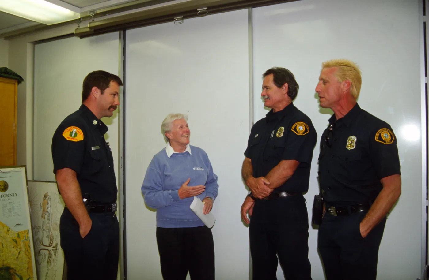 Cherie Bratt talks with local fire fighters during a drill