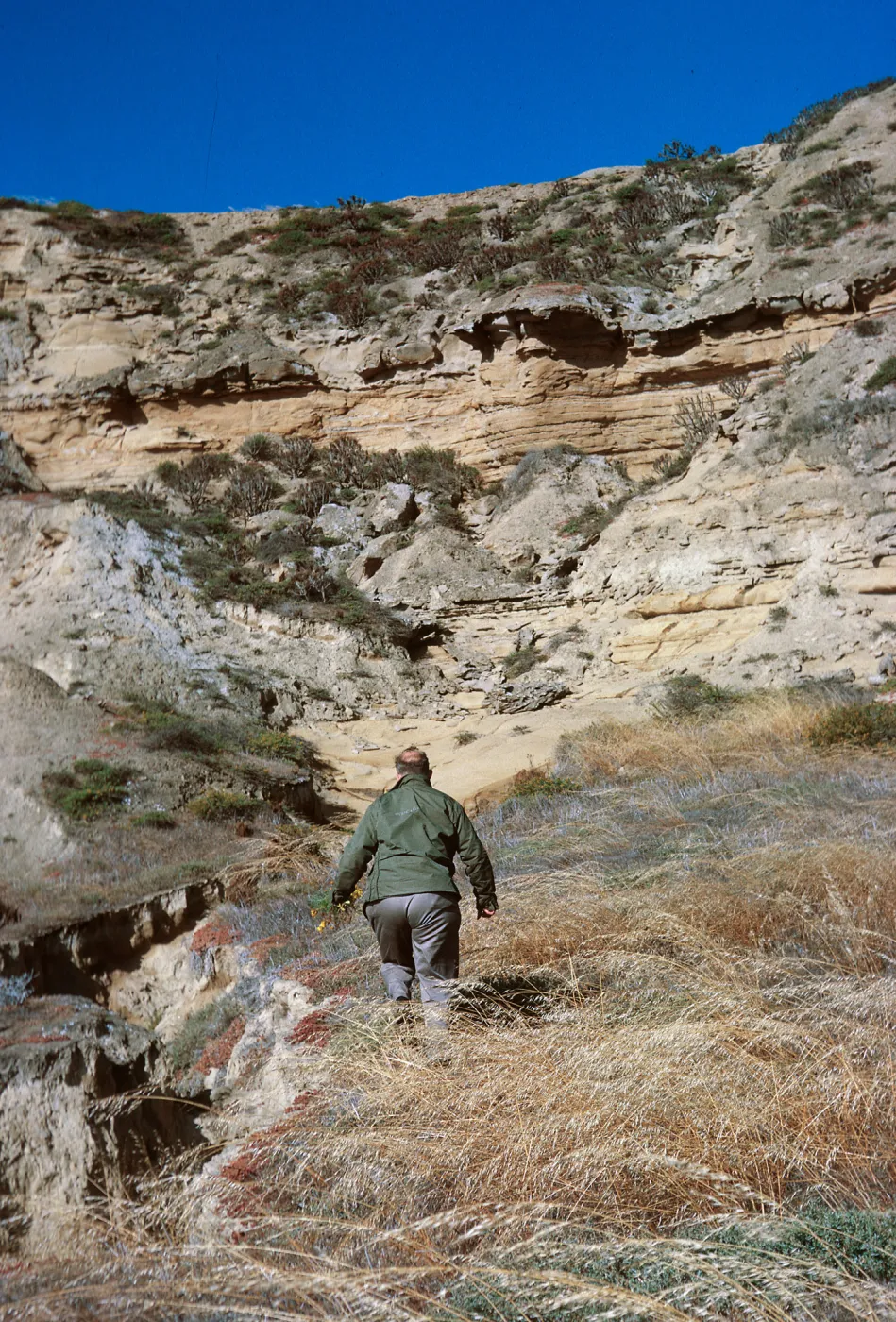 6/ Sam Rainey exploring canyon, 65-126 & SN-43