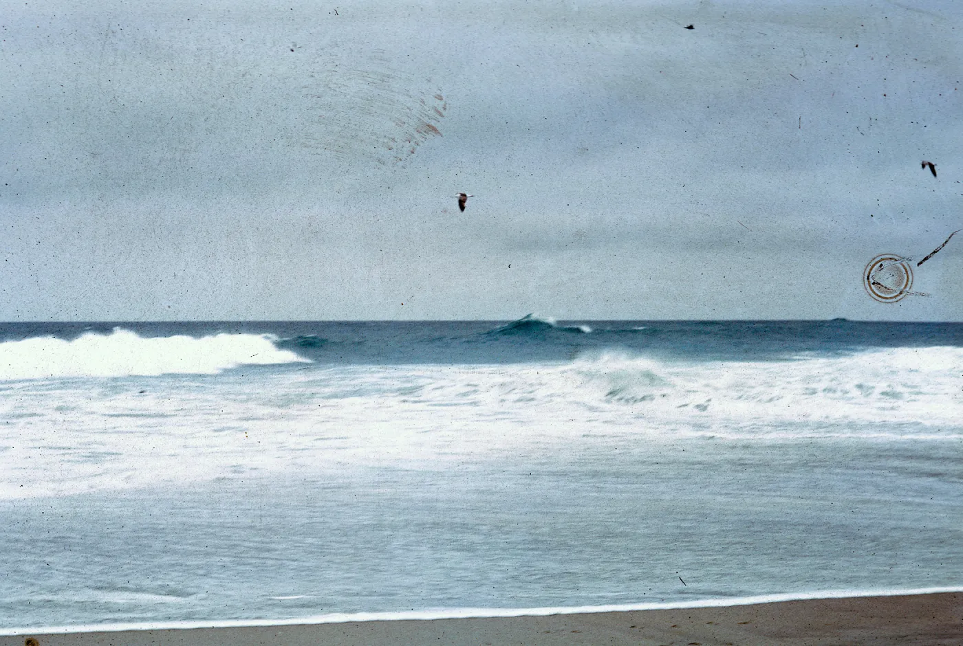 waves breaking on sandspit, 66-81 & SN-337