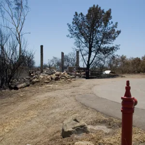 East Slope driveway with water valve,burned Gane House behind, after the Jesusita Fire