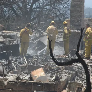 Firefighters put out a hot spot at the Gane House site, after the Jesusita Fire
