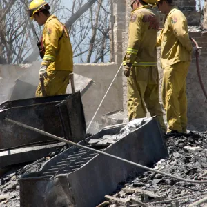 Firefighters put out a hot spot at the Gane House site, after the Jesusita Fire