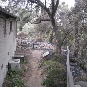 Path on west side of the Cottage, burned ramains of the Home Demonstration Deck after the Jesusita Fire