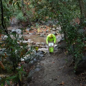 Posting warning signs at lower creek crossing after rain storm
