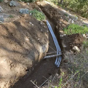Power and data conduit being installed in the Arroyo Section