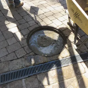 Filling septic tank at entrance with cement slurry