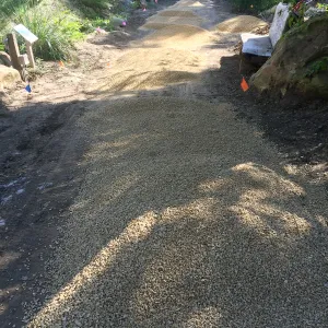 Spreading California gold gravel in Arroyo