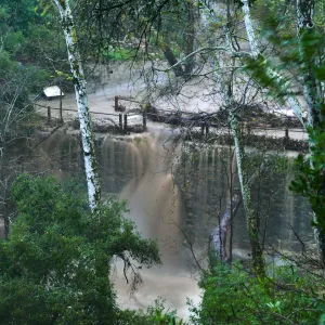 Mission Creek cresting Mission Dam during rainstorm