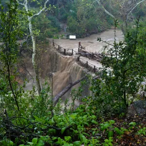 Mission Creek cresting Mission Dam during rainstorm