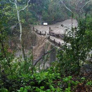Mission Creek cresting Mission Dam during rainstorm