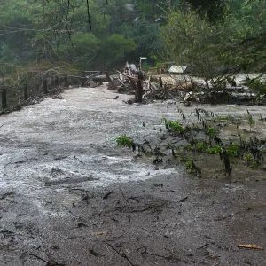 Debris accumulation at Mission Dam during rainstorm