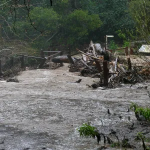 Debris accumulation at Mission Dam during rainstorm