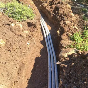 Power and data conduit being installed in the Arroyo Section