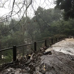 Debris accumulation at Mission Dam during rainstorm