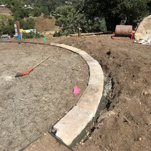 Construction of stone edging in Island View Garden lawn