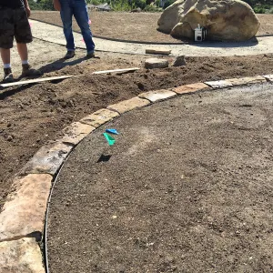 Construction of stone edging in Island View Garden lawn