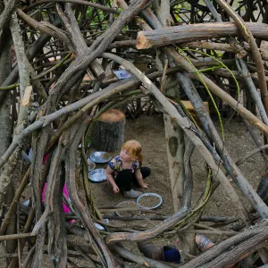 Santa Barbara Botanic Garden Casitas Opening, child playing in the â€œWoodrat Houseâ€ Casita